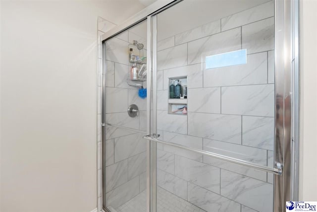 bathroom with a shower with shower door