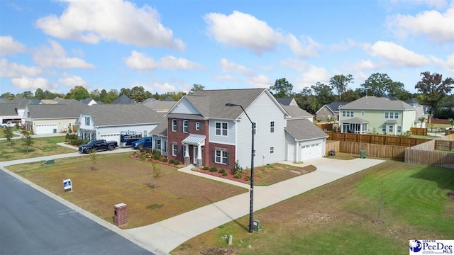 view of front of home with a garage and a front lawn