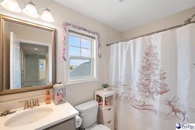 bathroom featuring vanity and toilet