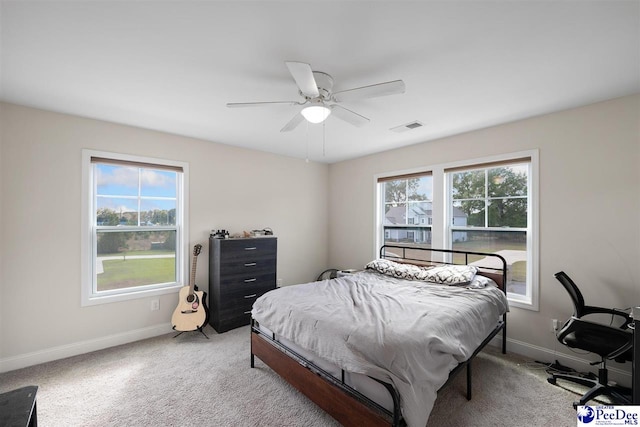 bedroom with light colored carpet, visible vents, and baseboards