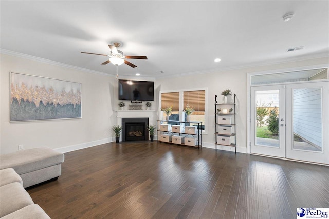 unfurnished living room featuring ornamental molding, ceiling fan, dark hardwood / wood-style flooring, and french doors