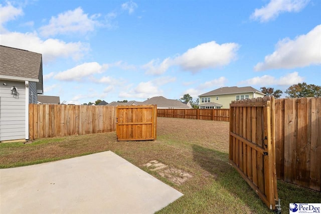 view of yard featuring a patio area and a fenced backyard