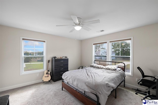 bedroom with light colored carpet and ceiling fan