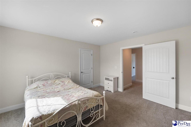 carpeted bedroom with baseboards