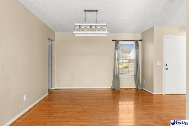 empty room featuring hardwood / wood-style floors and a textured ceiling