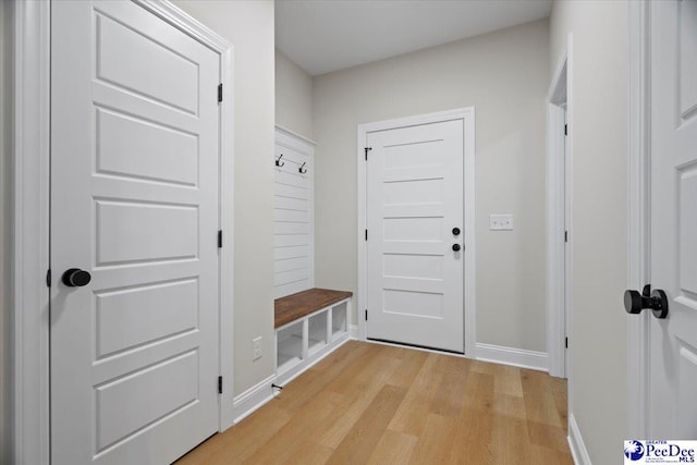 mudroom with baseboards and light wood-style floors