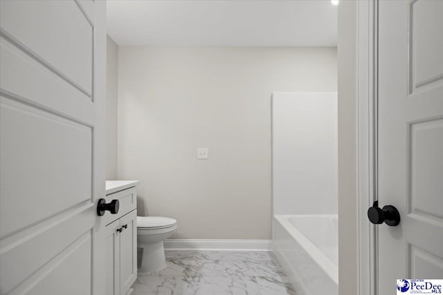 full bathroom featuring a bathtub, marble finish floor, toilet, vanity, and baseboards