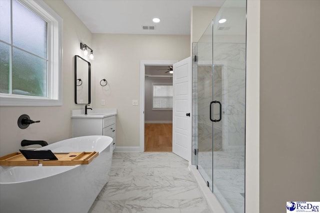 bathroom featuring a wealth of natural light, marble finish floor, visible vents, and a shower stall