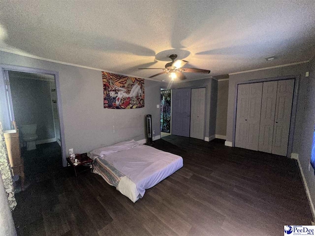 17 Shuler Dr, Sumter, SC 29150 - bedroom featuring a textured ceiling, dark wood-style flooring, crown molding, multiple closets, and a ceiling fan