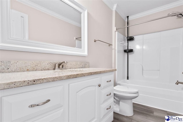 bathroom with toilet, ornamental molding, shower / bathing tub combination, wood finished floors, and vanity