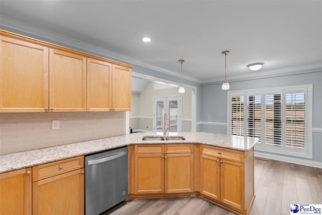 kitchen featuring a sink, light wood-style flooring, dishwasher, and a peninsula