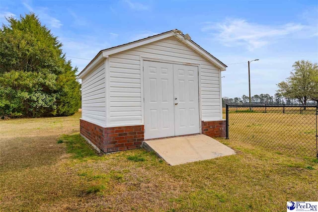 view of shed featuring fence