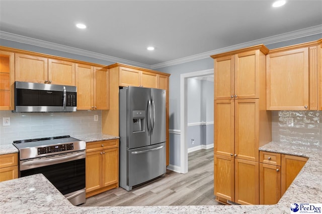 kitchen with light stone counters, ornamental molding, light wood finished floors, and stainless steel appliances