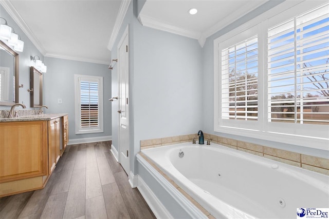 full bath featuring double vanity, a jetted tub, crown molding, and wood finished floors