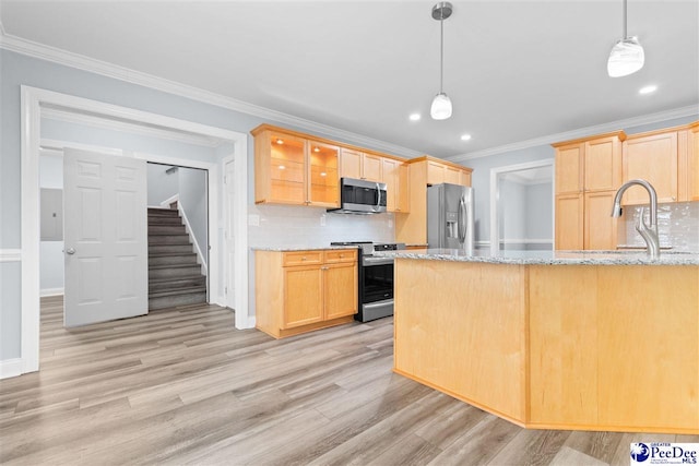 kitchen with ornamental molding, light brown cabinets, backsplash, appliances with stainless steel finishes, and light wood finished floors