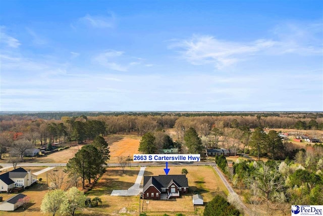 birds eye view of property with a view of trees