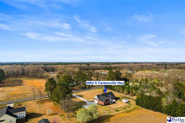 drone / aerial view with a wooded view