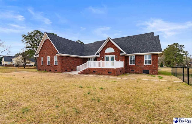 view of front of house with a front lawn, fence, and crawl space