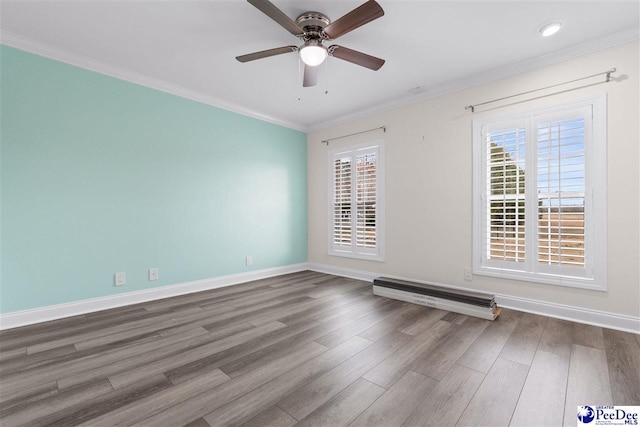 empty room with baseboards, wood finished floors, a ceiling fan, and ornamental molding