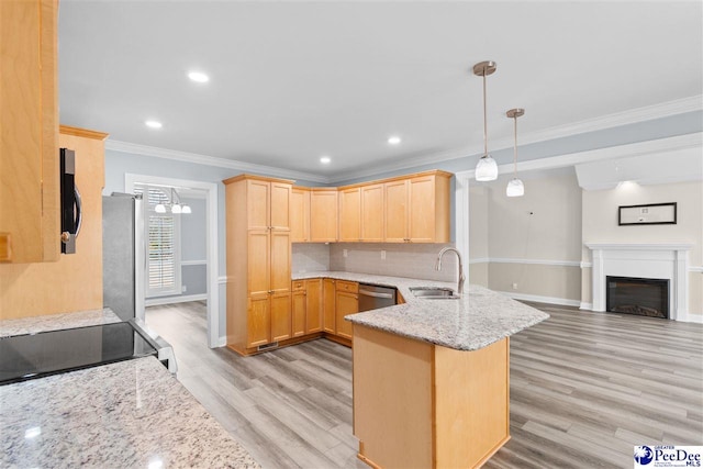 kitchen featuring a peninsula, a sink, decorative backsplash, light brown cabinetry, and appliances with stainless steel finishes