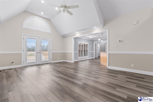 unfurnished living room with a ceiling fan, french doors, baseboards, dark wood-style flooring, and vaulted ceiling