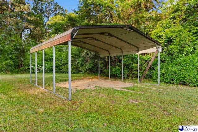 view of home's community featuring a lawn and a detached carport