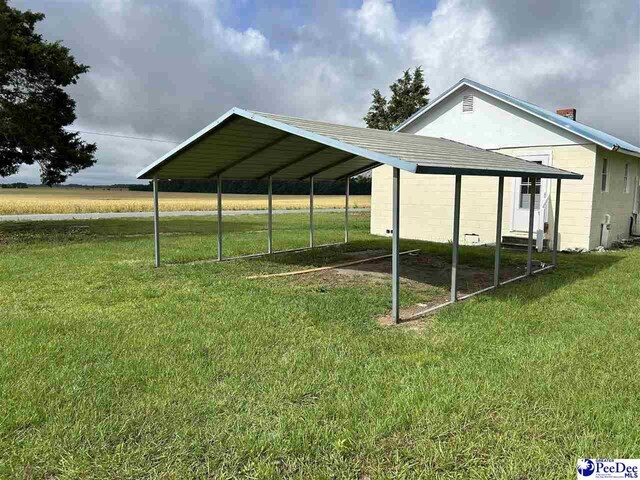 565 Davids Pond Rd, Bennettsville, SC 29512 - view of side of property featuring a yard and concrete block siding