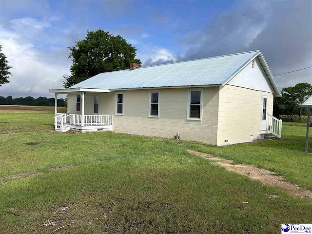 565 Davids Pond Rd, Bennettsville, SC 29512 - back of property featuring a porch, a yard, metal roof, concrete block siding, and entry steps