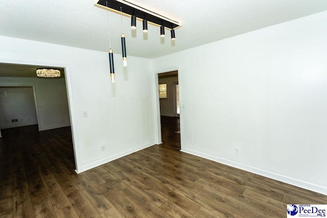 2318 Heron Dr, Florence, SC 29501 - spare room featuring dark wood-type flooring and a textured ceiling