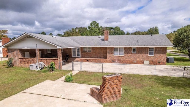 2318 Heron Dr, Florence, SC 29501 - rear view of property featuring a yard, a patio area, and central air condition unit