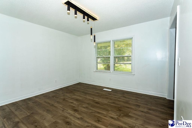 2318 Heron Dr, Florence, SC 29501 - unfurnished room featuring track lighting, a textured ceiling, and dark hardwood / wood-style flooring