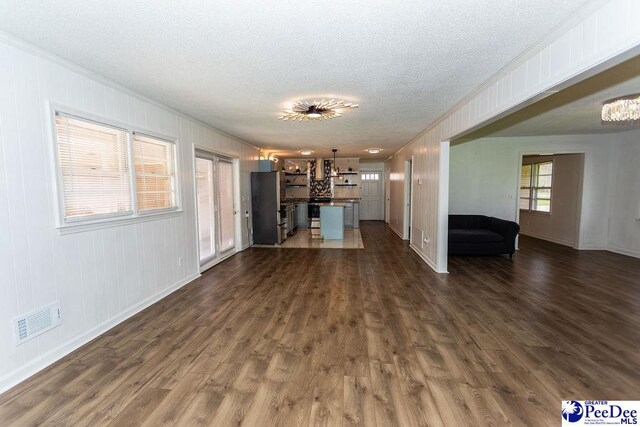 2318 Heron Dr, Florence, SC 29501 - unfurnished living room with ornamental molding, dark hardwood / wood-style floors, and a textured ceiling