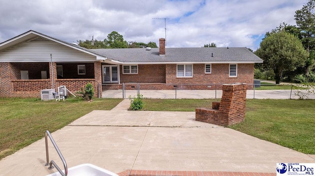 2318 Heron Dr, Florence, SC 29501 - rear view of property with a yard and central air condition unit