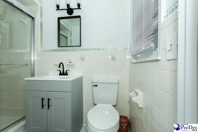 2318 Heron Dr, Florence, SC 29501 - bathroom featuring vanity, an enclosed shower, tile walls, and toilet