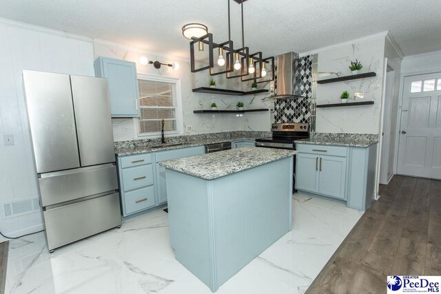 2318 Heron Dr, Florence, SC 29501 - kitchen featuring a kitchen island, appliances with stainless steel finishes, decorative light fixtures, crown molding, and wall chimney range hood