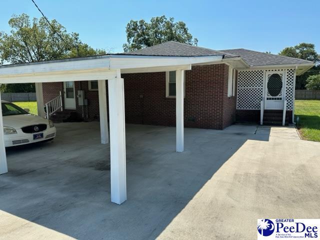 rear view of property featuring a carport