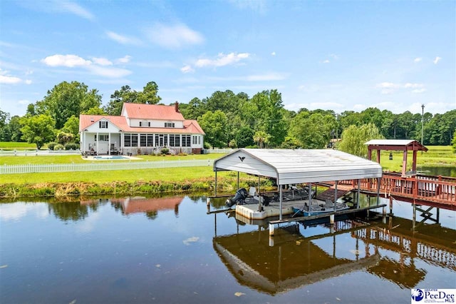 dock area with a water view and a yard