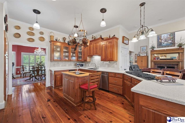 kitchen featuring dark hardwood / wood-style floors, stainless steel dishwasher, sink, and a kitchen island with sink