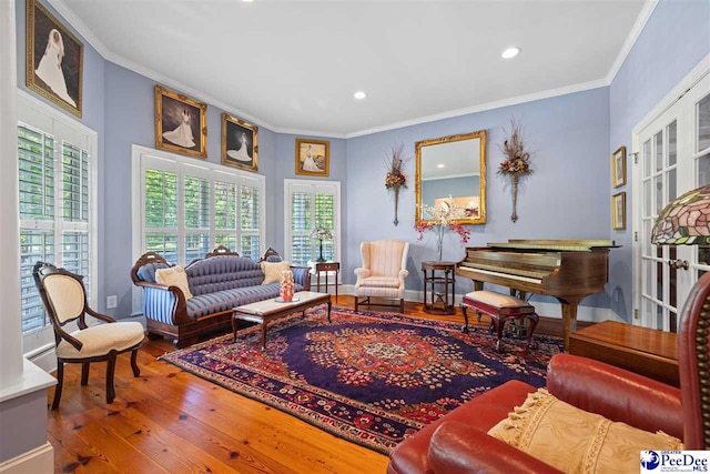 living room with ornamental molding and hardwood / wood-style floors