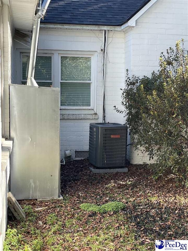 view of side of home featuring cooling unit