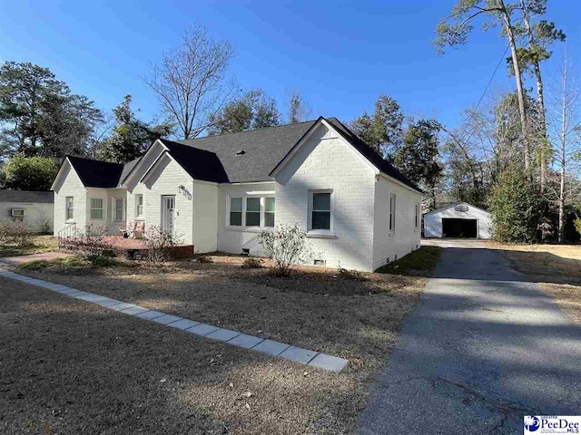 view of front facade with a garage and an outbuilding