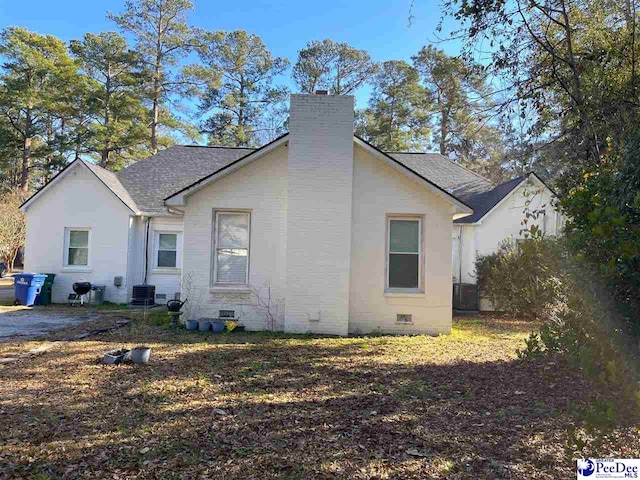 back of house with central air condition unit