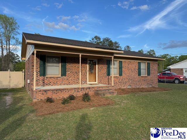 1612 Forest Dr, Dillon, SC 29536 - view of front of property featuring covered porch, brick siding, a front yard, fence, and a gate