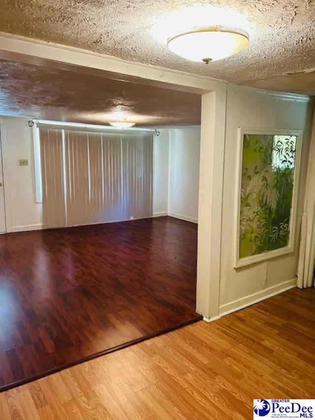 interior space featuring hardwood / wood-style floors and a textured ceiling