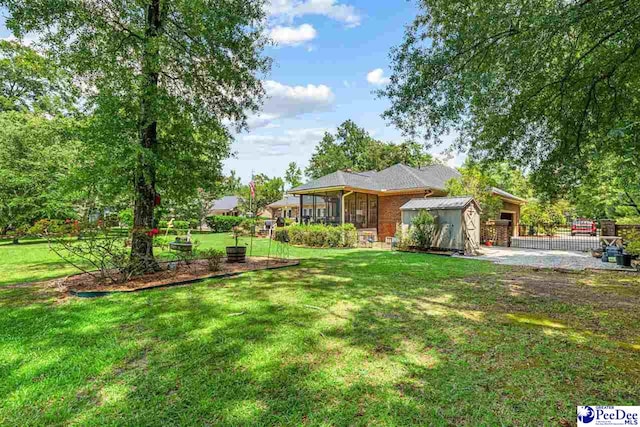 4105 Byrnes Blvd, Florence, SC 29506 - view of grassy yard featuring an attached garage and an outdoor structure