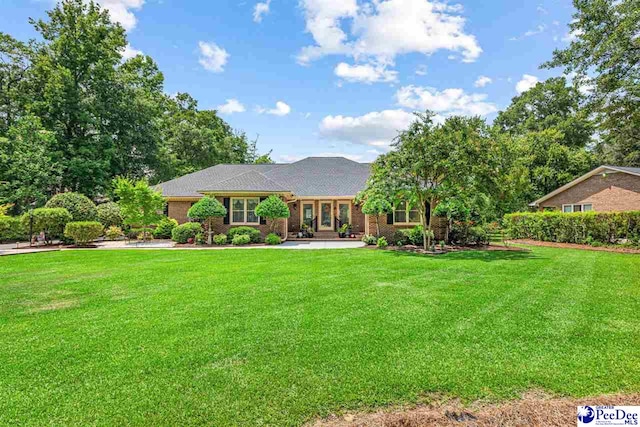 4105 Byrnes Blvd, Florence, SC 29506 - ranch-style home with a front yard, brick siding, and a patio area