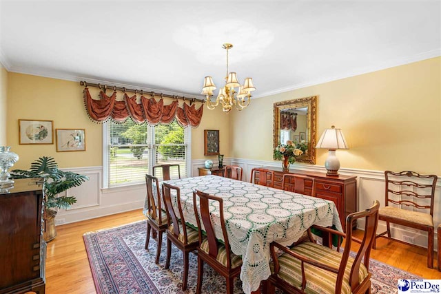 4105 Byrnes Blvd, Florence, SC 29506 - dining space with a chandelier, ornamental molding, wainscoting, and light wood-type flooring