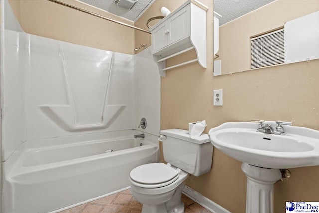 bathroom with toilet, bathing tub / shower combination, tile patterned flooring, and a textured ceiling