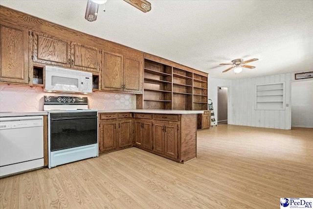 kitchen with ceiling fan, a textured ceiling, white appliances, and light hardwood / wood-style flooring