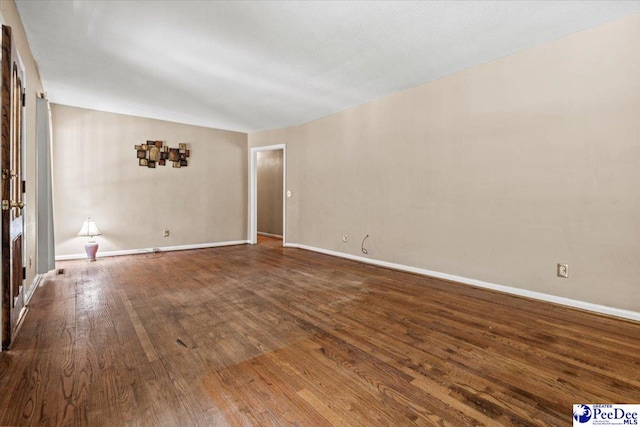 unfurnished room featuring dark wood-type flooring